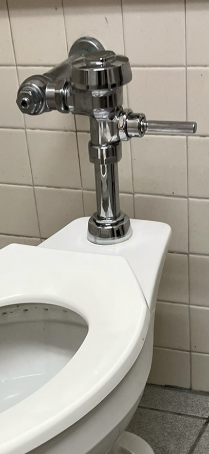 A close up of a toilet flush valve. A close up of a toilet flush valve.