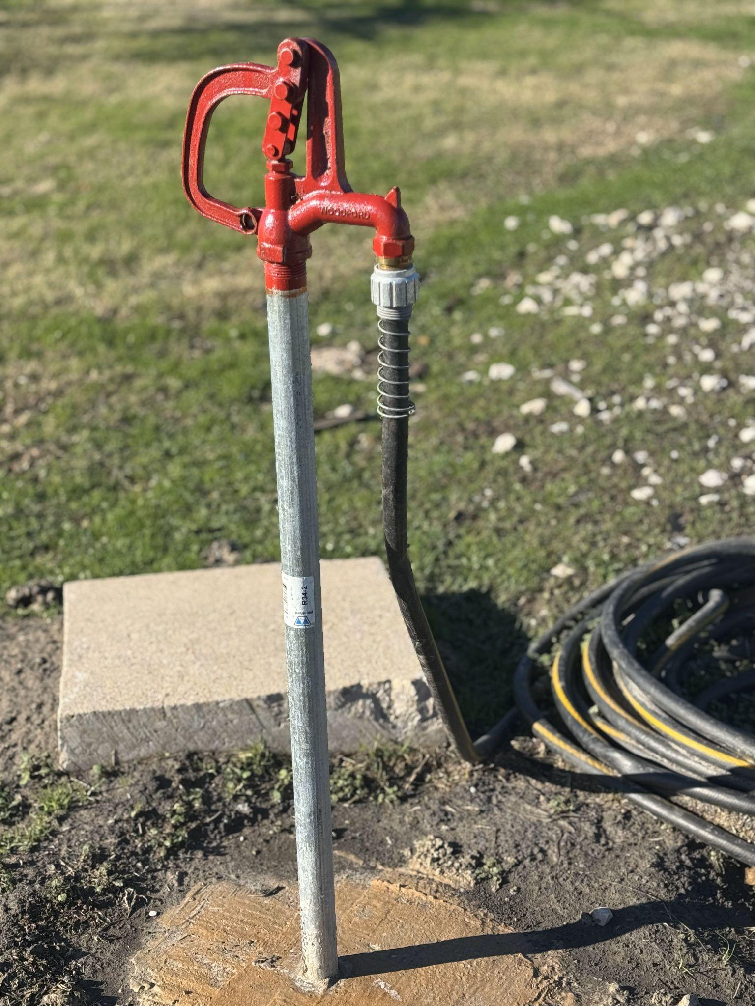 A yard hydrant in the ground.