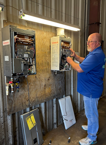 A plumber repairing a tankless water heater.