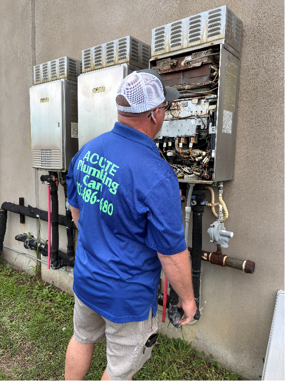 Licensed plumber inspecting and maintaining water system equipment outside a building